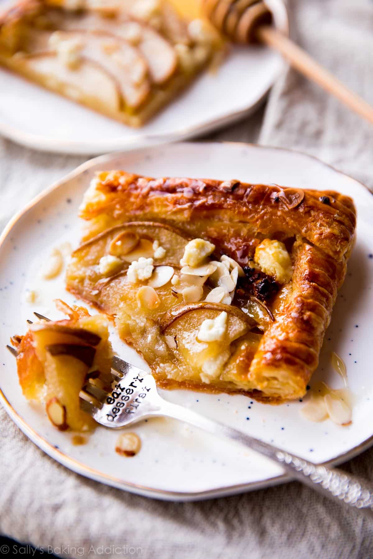 slice of honey pear tart on a white plate with a fork