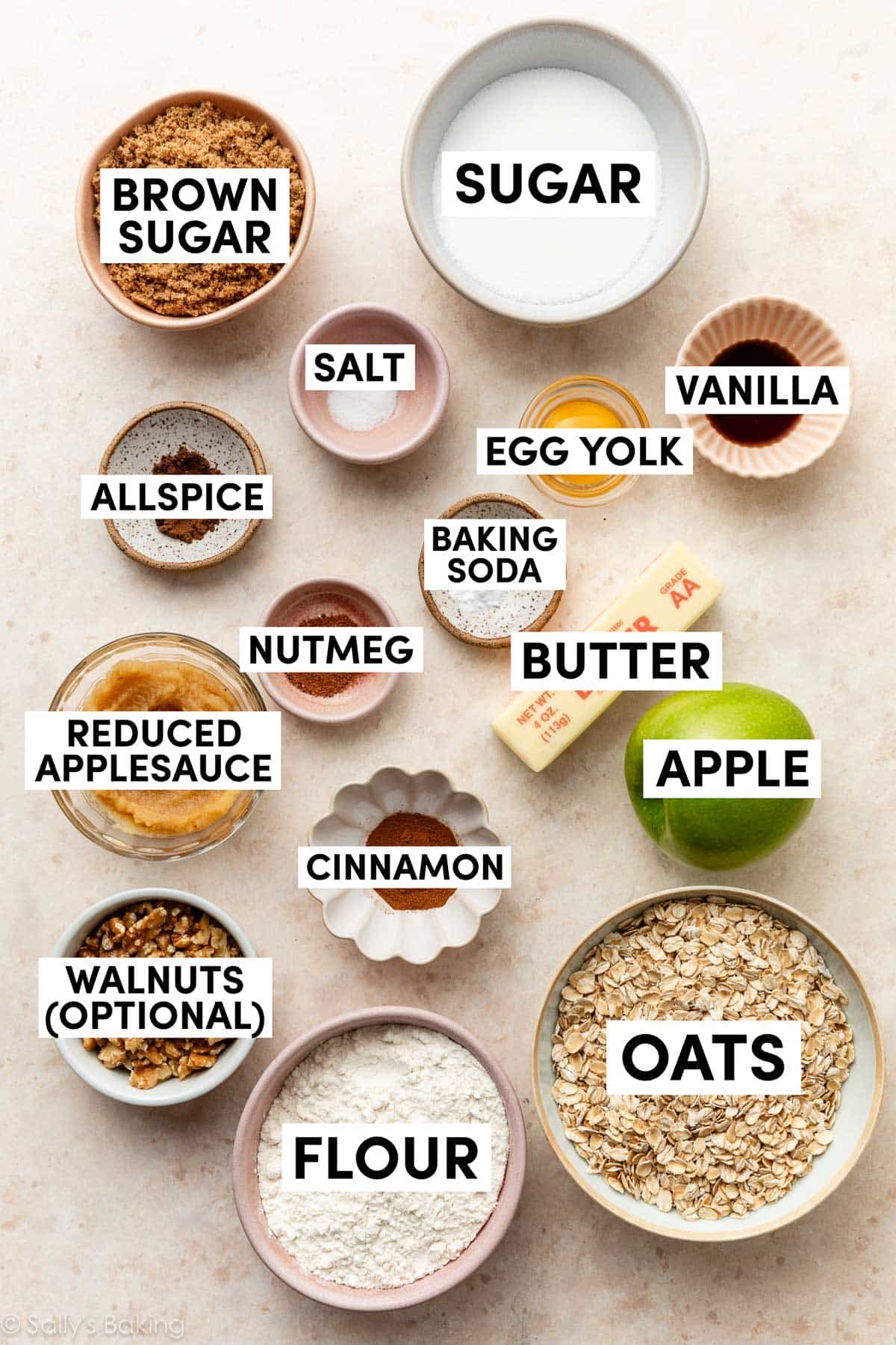 ingredients measured out in bowls including sugar, brown sugar, oats, flour, baking soda, applesauce, cinnamon, walnuts, vanilla, and allspice.
