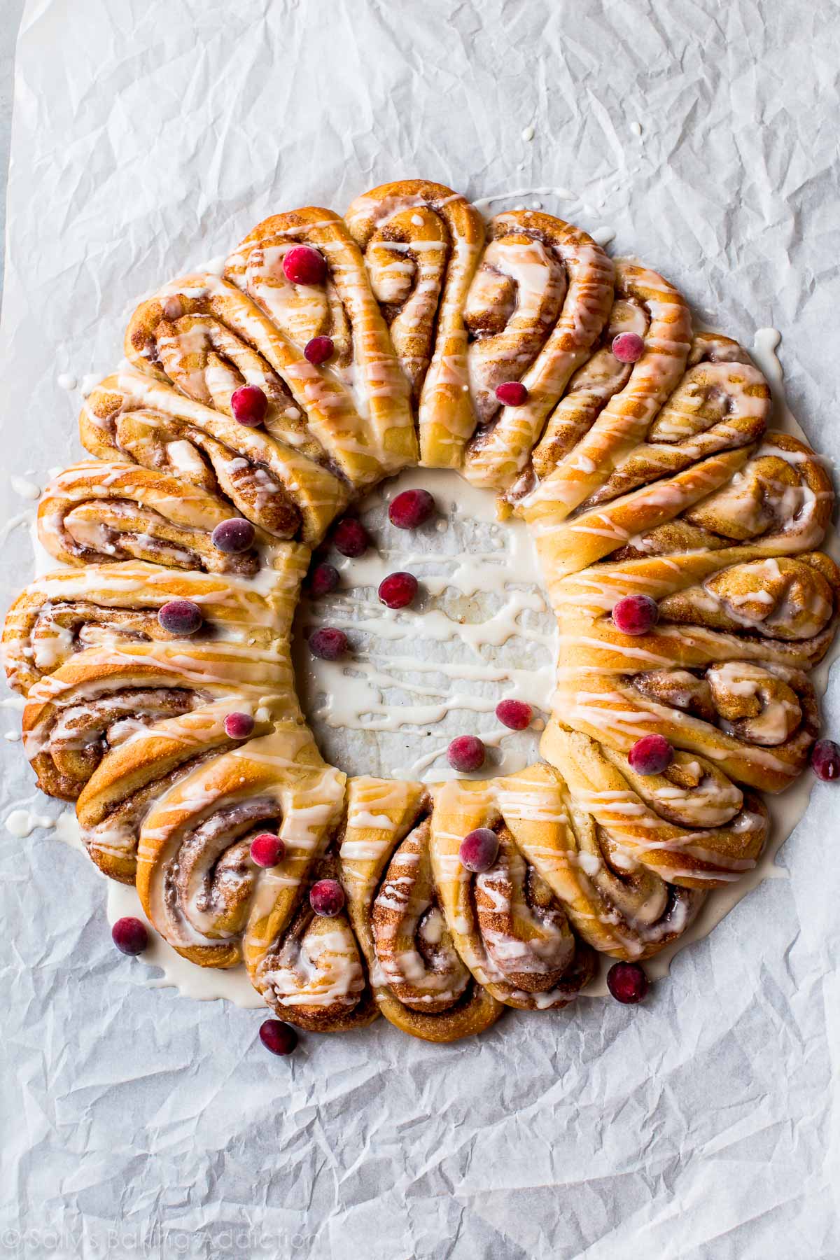 overhead image of cinnamon roll wreath with vanilla icing