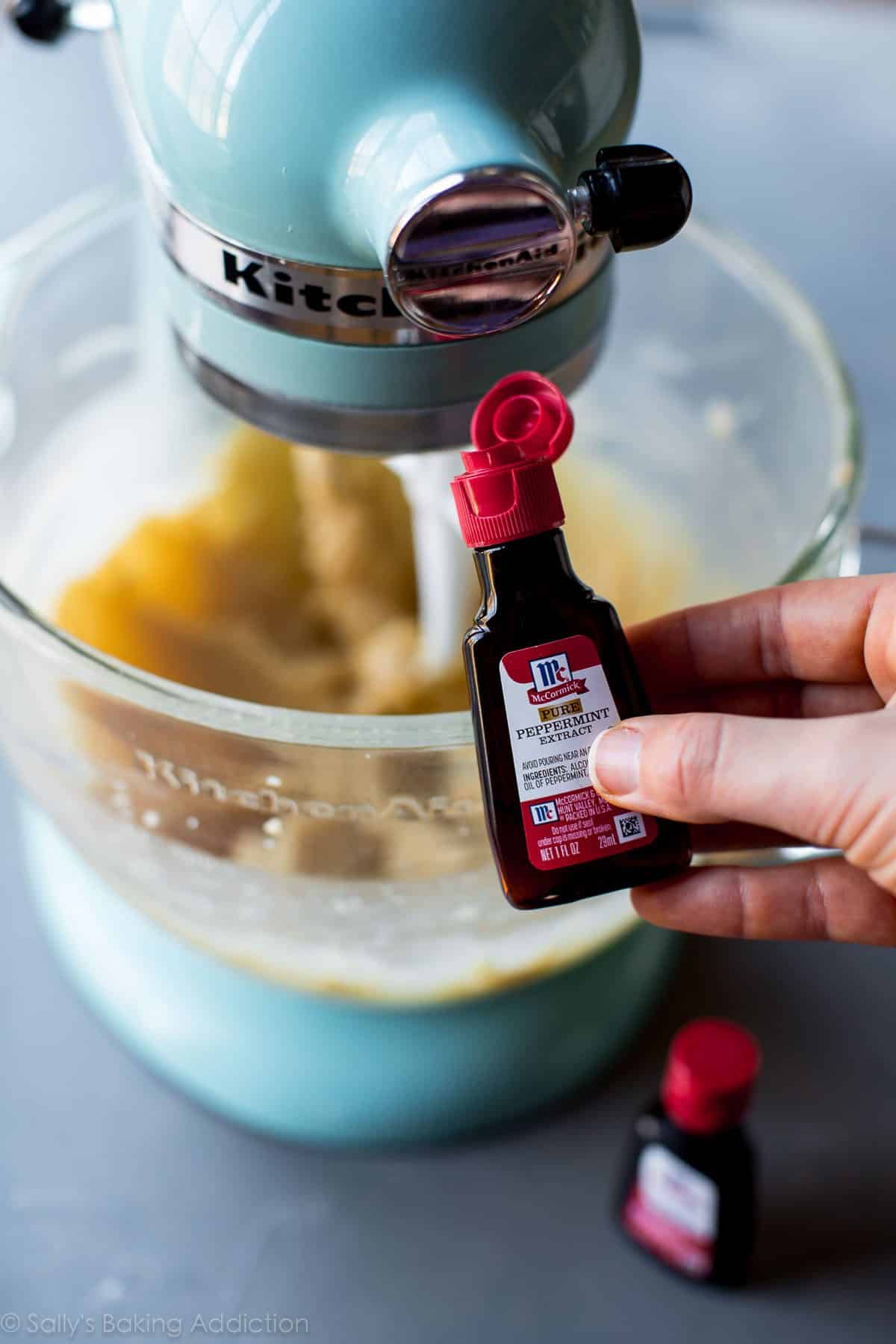 hands holding a bottle of peppermint extract