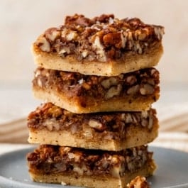 stack of pecan pie bars on plate.