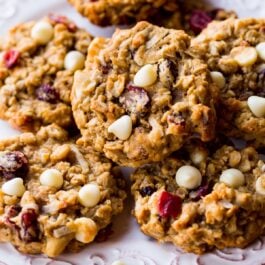 white chocolate cranberry coconut pecan oatmeal cookies on a white plate