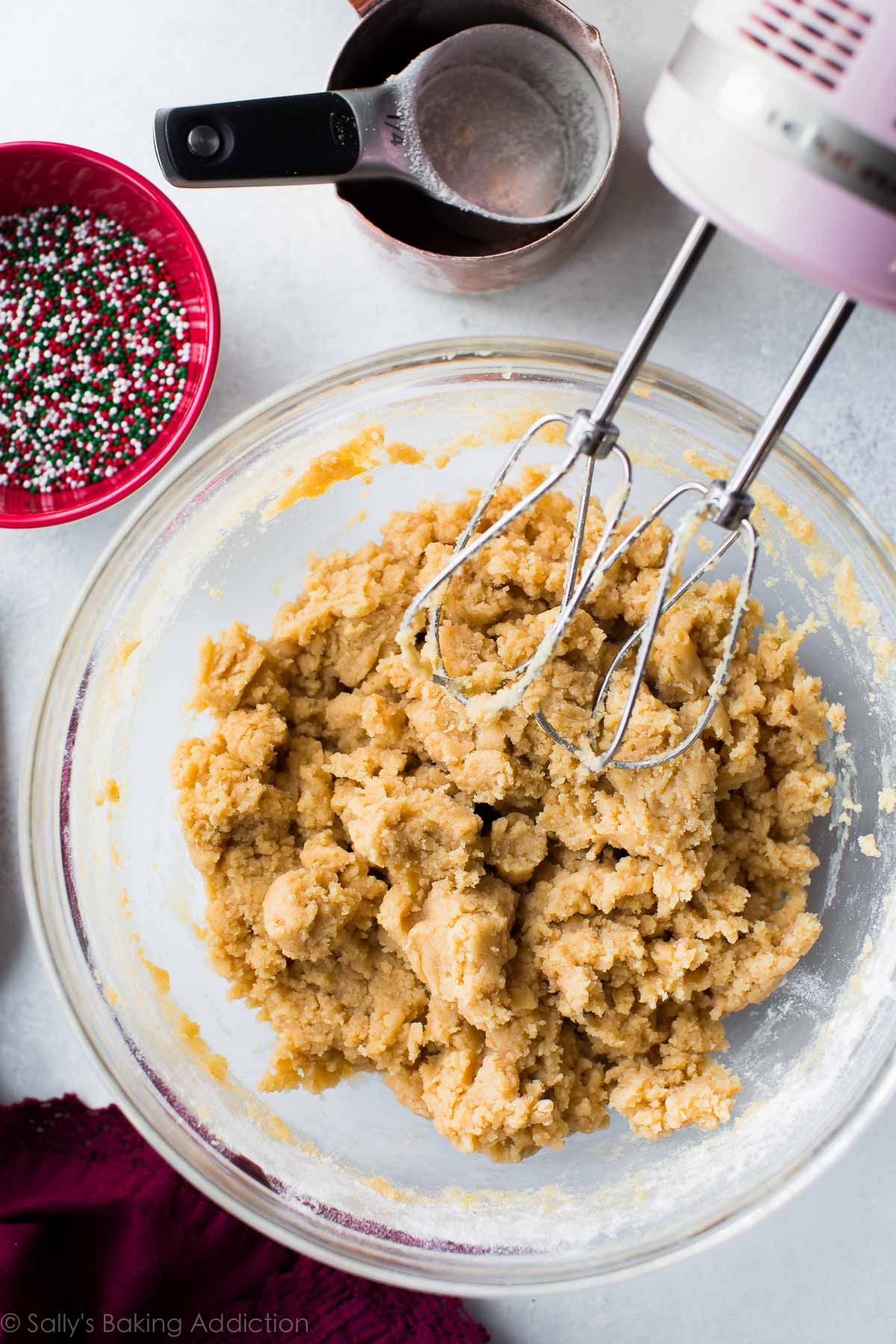 sugar cookie dough in a glass bowl with a hand mixer