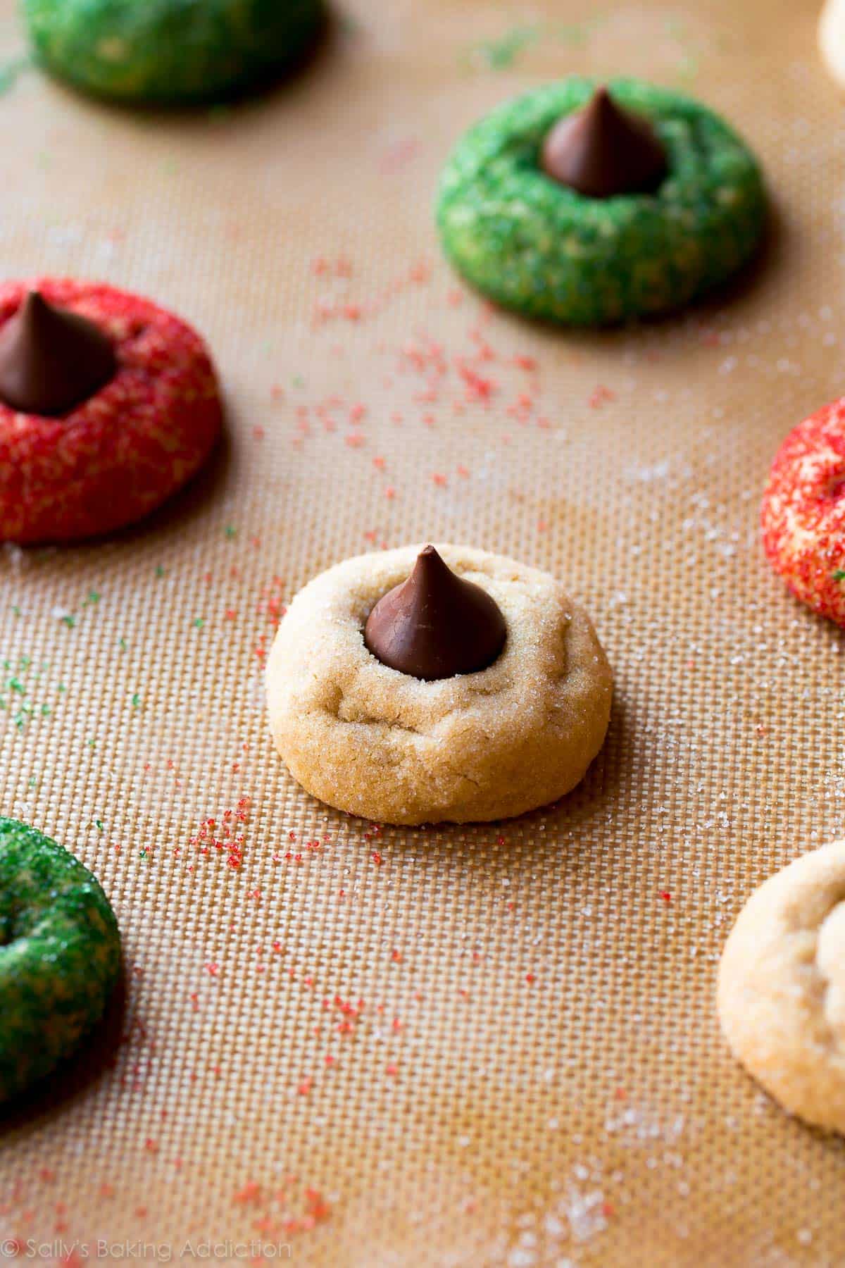 peanut butter blossoms on a silpat baking mat after baking