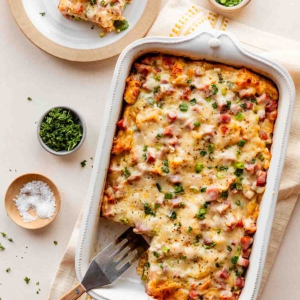 ham, egg, and cheese breakfast strata in white dish.