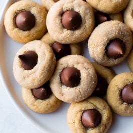 overhead image of peanut butter blossoms on a white plate