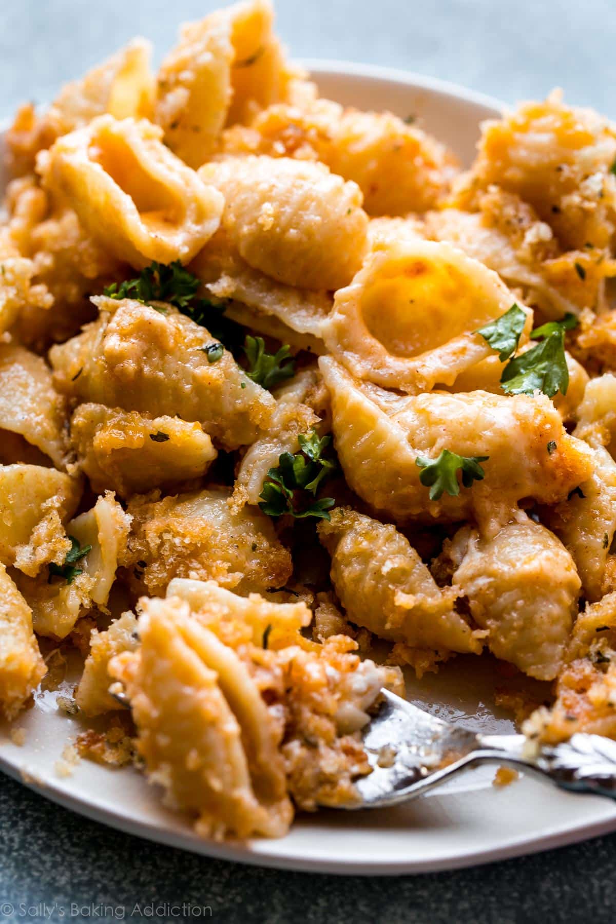 baked macaroni and cheese on a plate with a fork