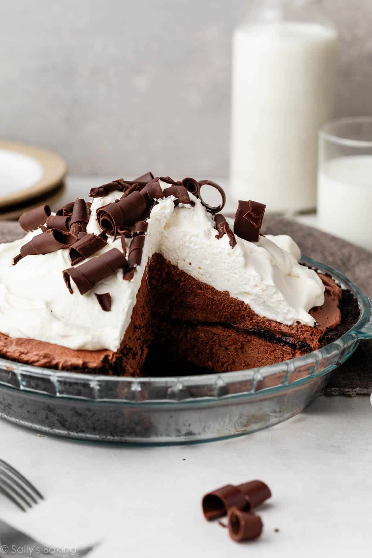sky-high chocolate mousse pie with whipped cream and chocolate curls.