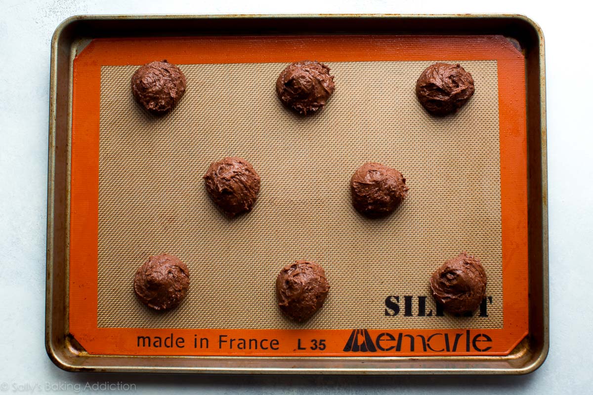 chocolate whoopie pie batter on a baking sheet before baking