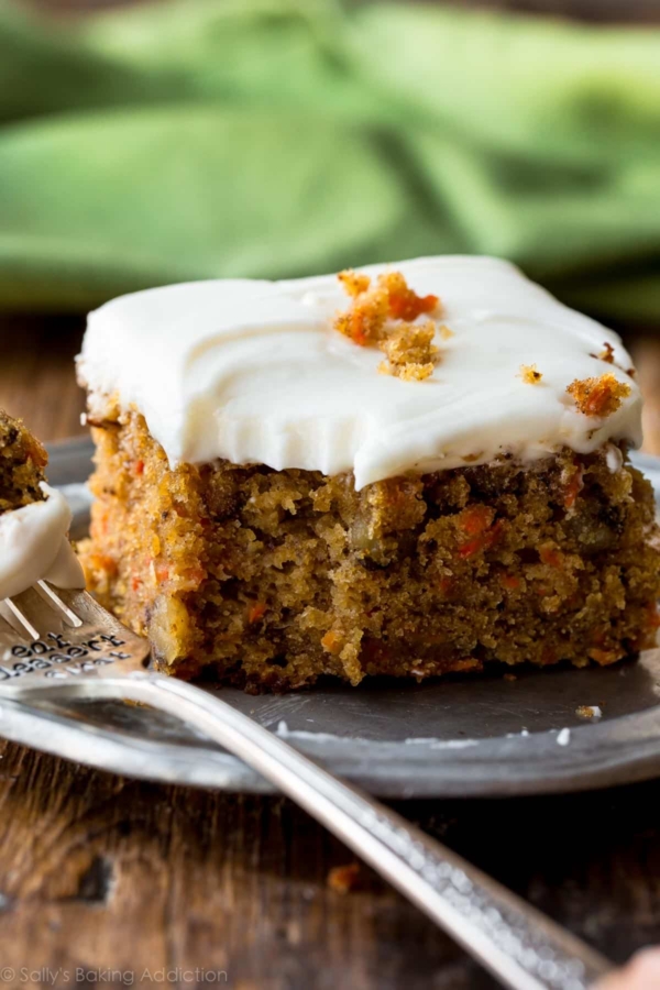 slice of pineapple carrot cake on a silver plate with a fork