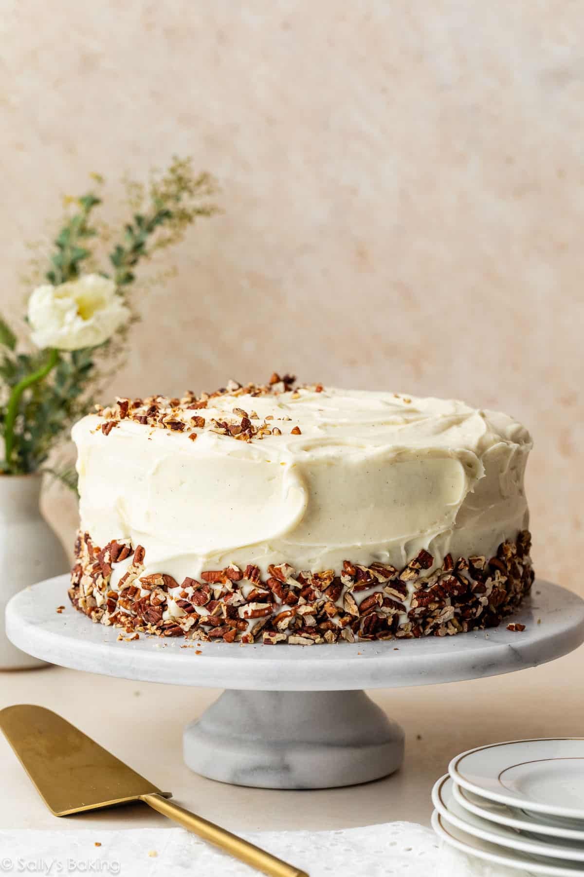 cream cheese frosted cake with pecans around the edge.