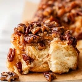 close-up of a biten pecan sticky bun.