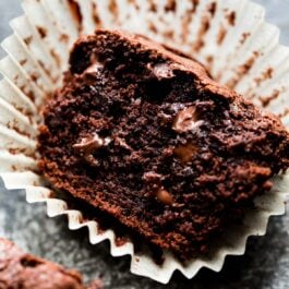 triple chocolate muffin cut in half in a muffin liner