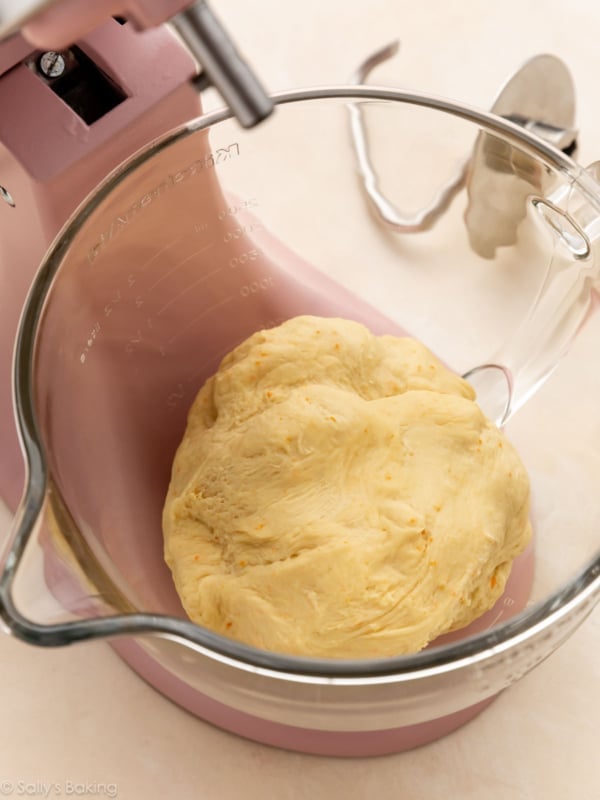 orange dough in stand mixer bowl.