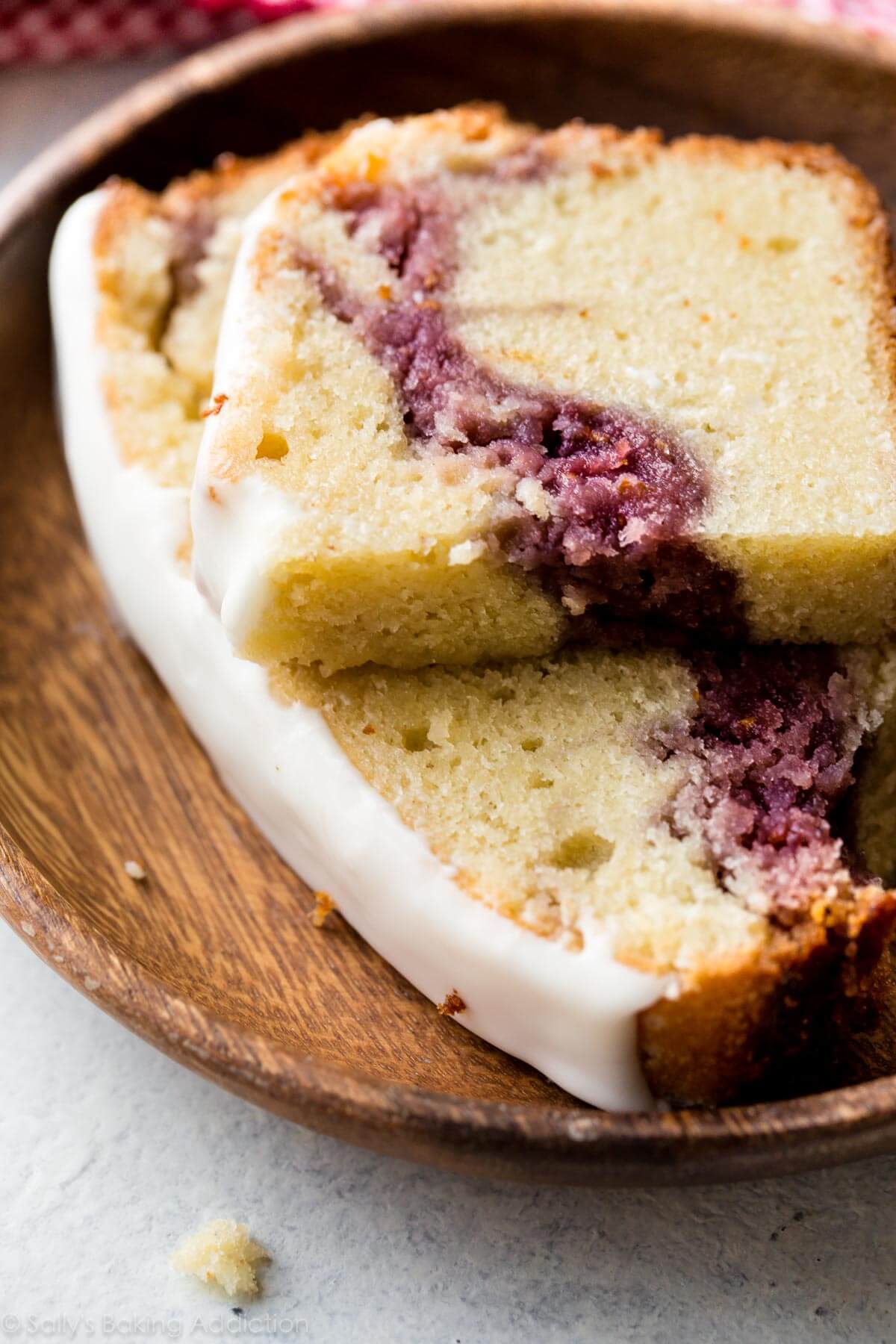 slices of raspberry swirl pound cake on a wood plate