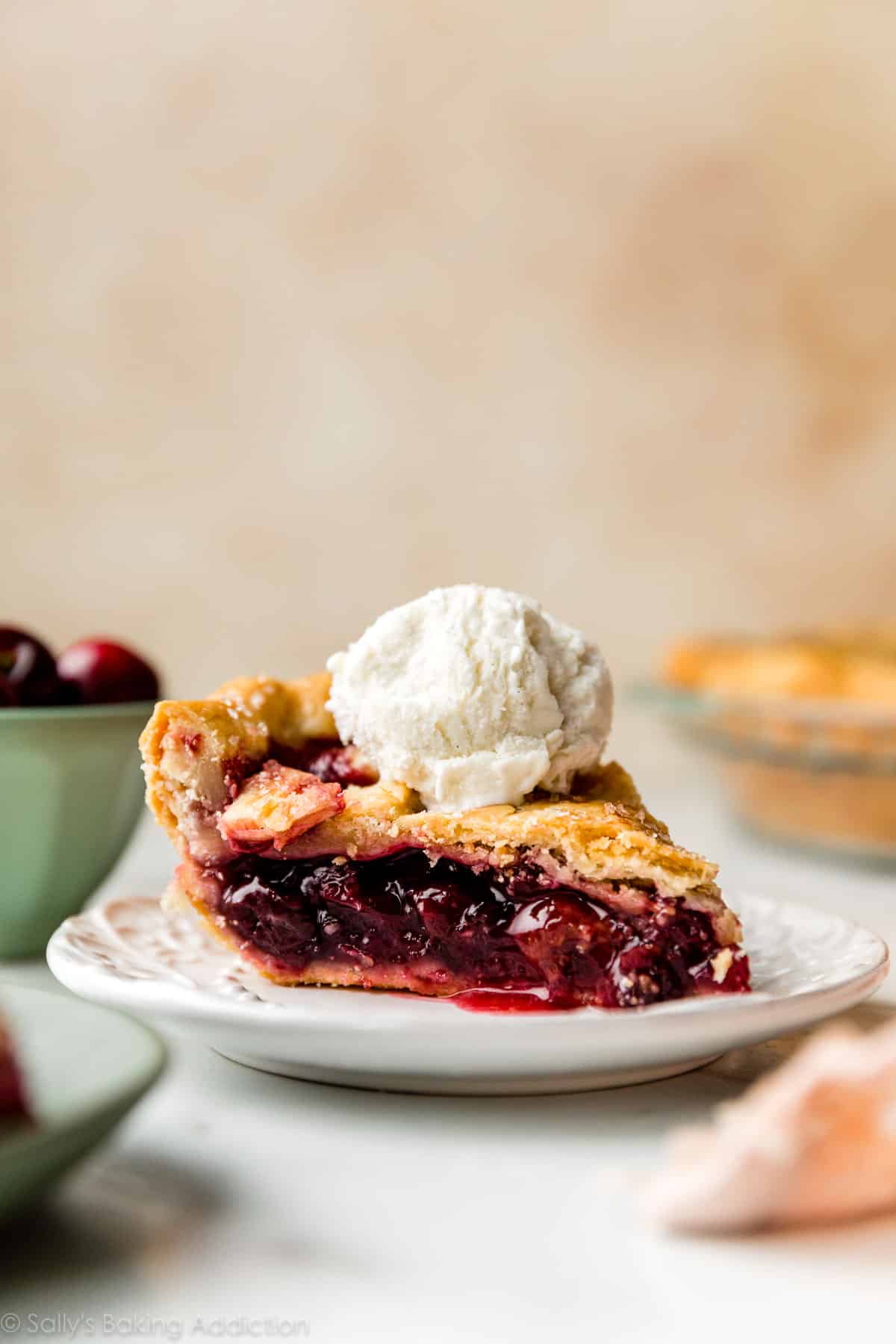 cherry pie slice with vanilla ice cream on top