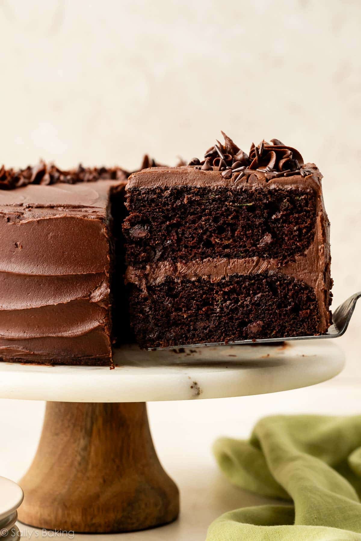 cake server removing slice of chocolate zucchini cake.