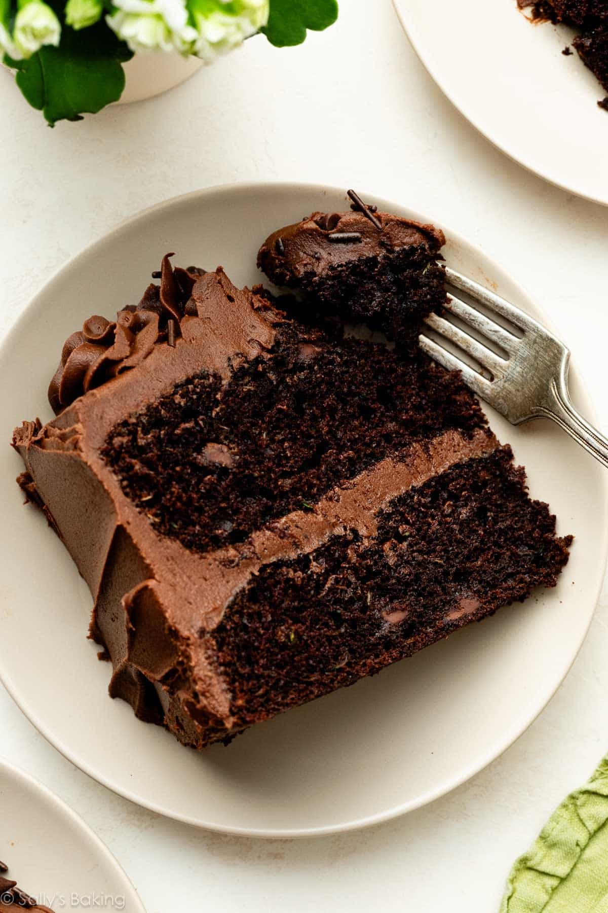 fork with a bite of a slice of chocolate zucchini cake.