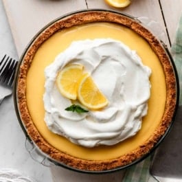 creamy lemon pie with whipped cream and graham cracker crust.