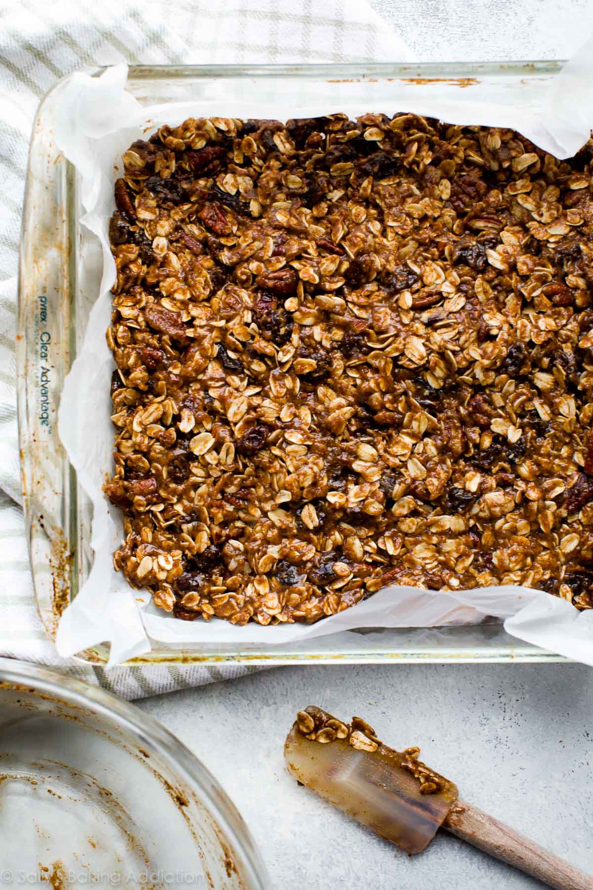 oatmeal raisin granola bars in a glass baking pan before baking