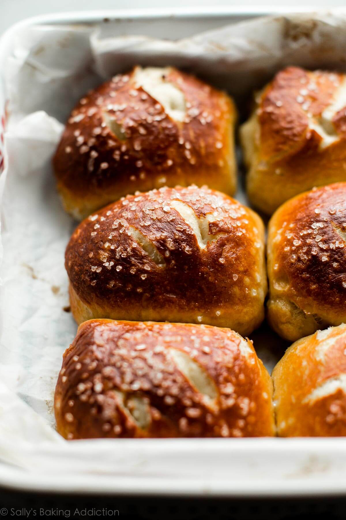 soft pretzel rolls in a baking dish after baking