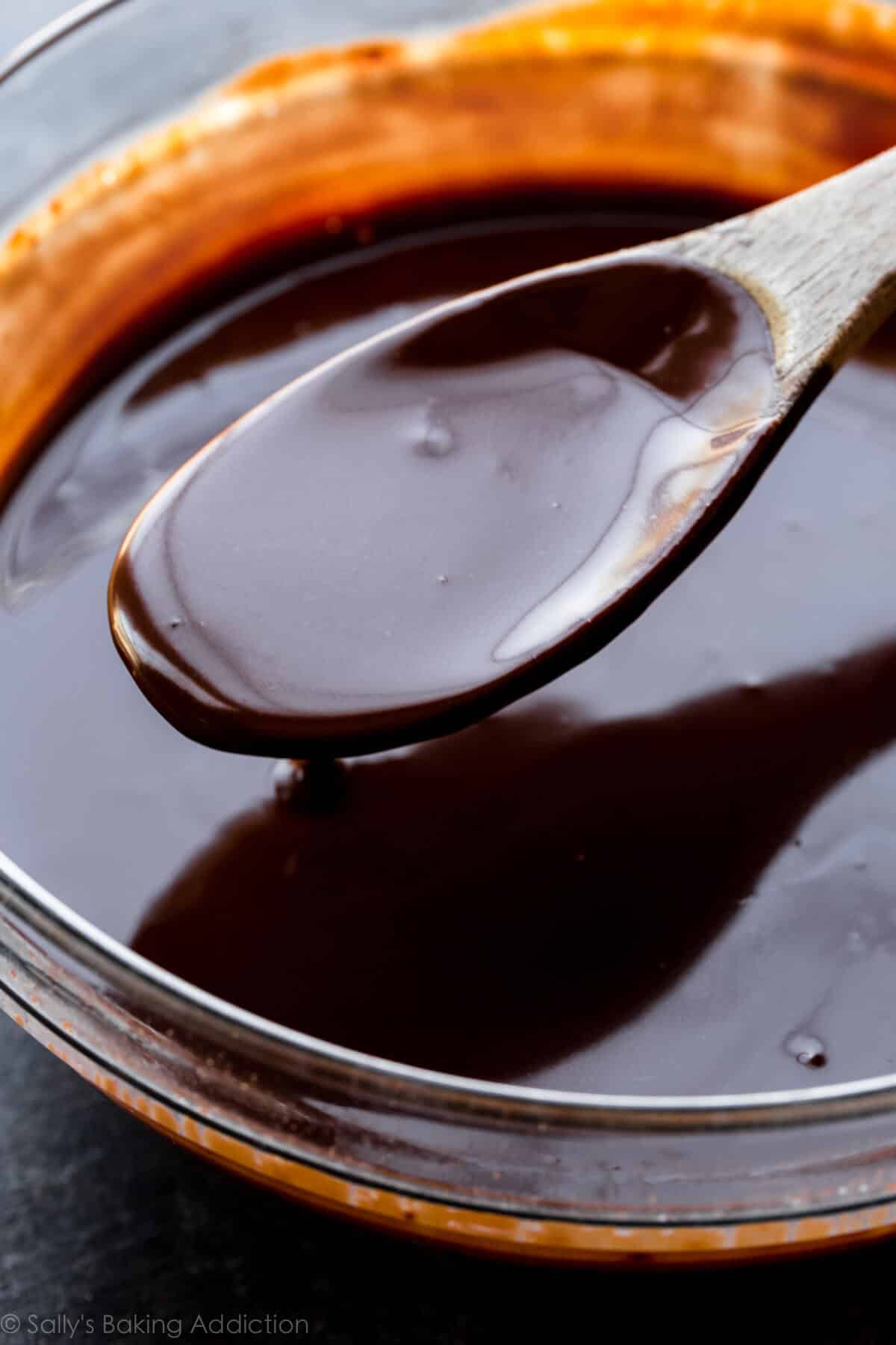 chocolate filling in a glass bowl with a wood spoon