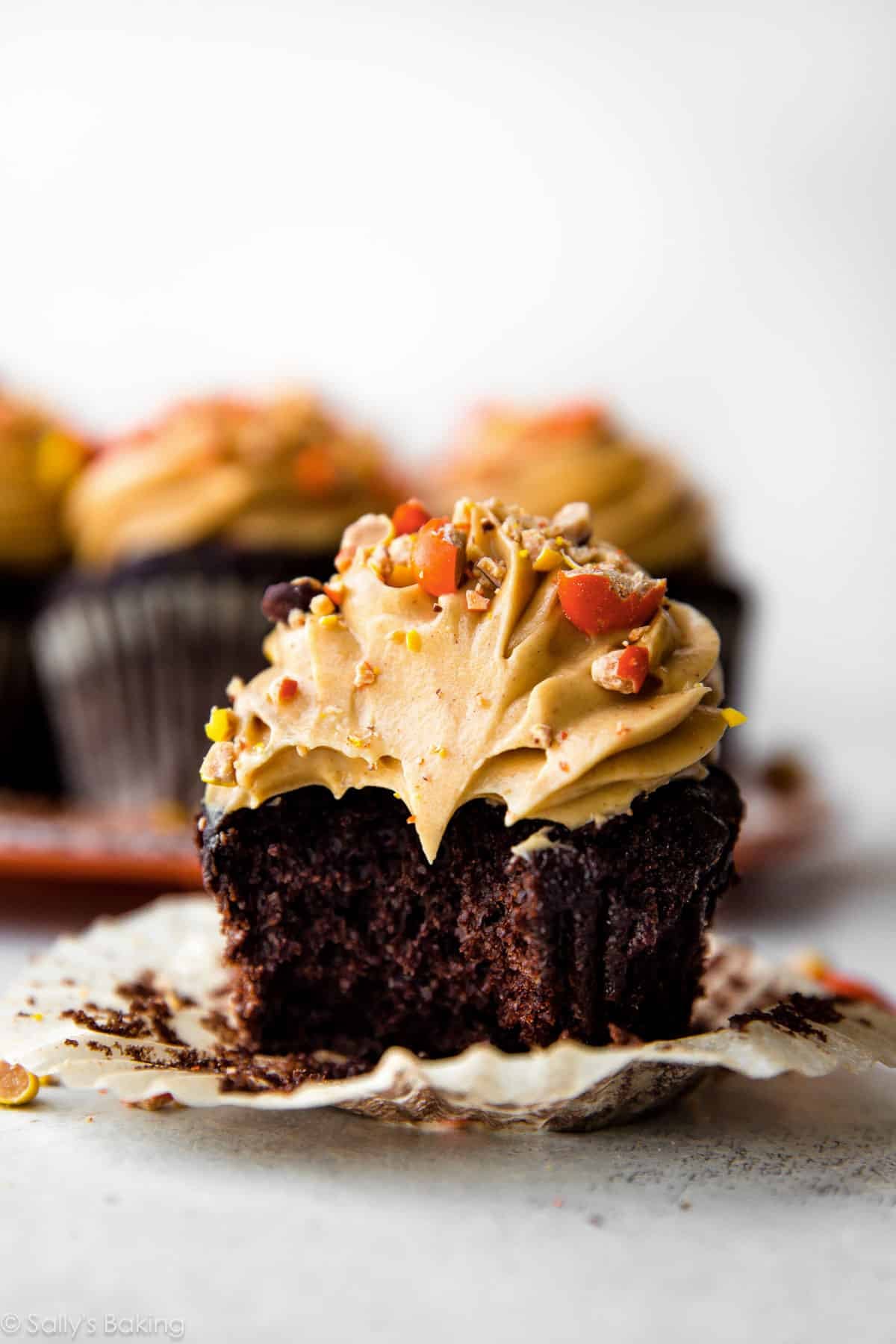 chocolate peanut butter cupcake with bite taken out.
