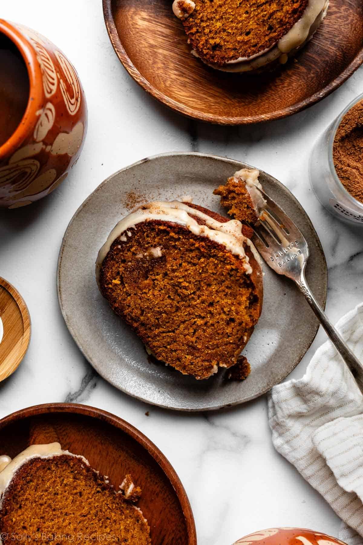 overhead photo of slices of pumpkin Bundt cake with maple icing on top on plates.