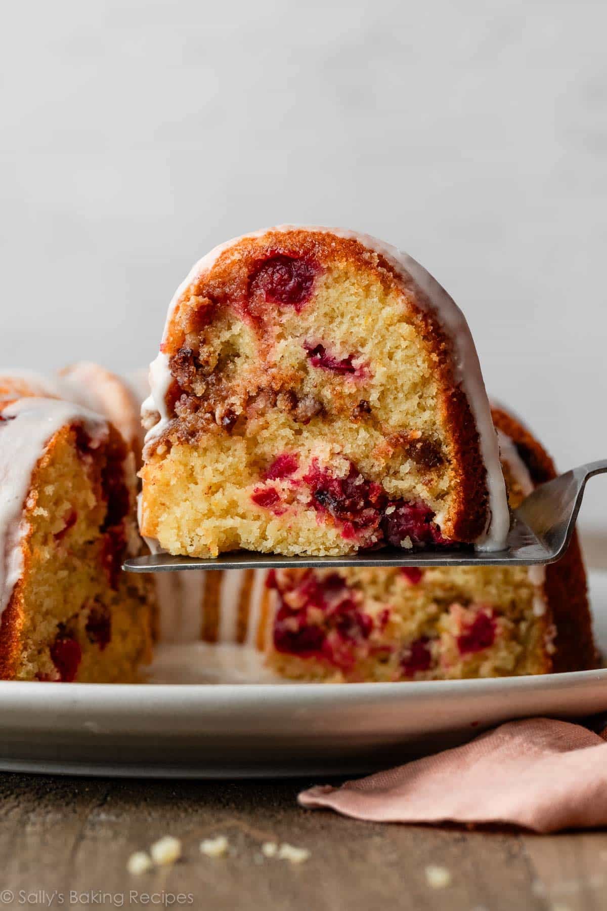 slice of cranberry orange Bundt cake with cinnamon swirl.