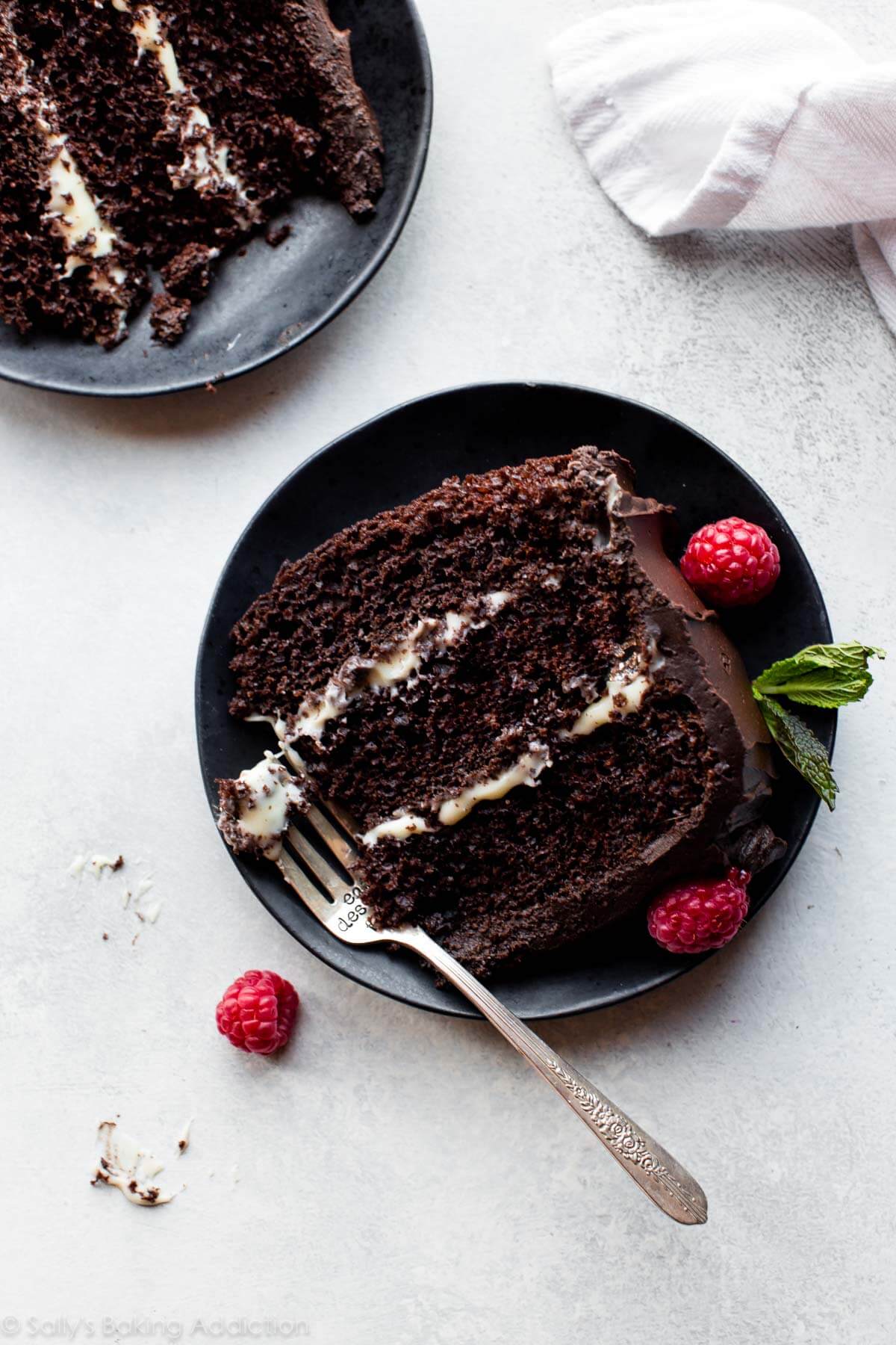 slice of tuxedo cake on a black plate with a fork