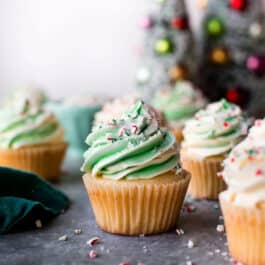 peppermint cupcakes with white and green swirled white chocolate frosting with crushed candy canes and sprinkles