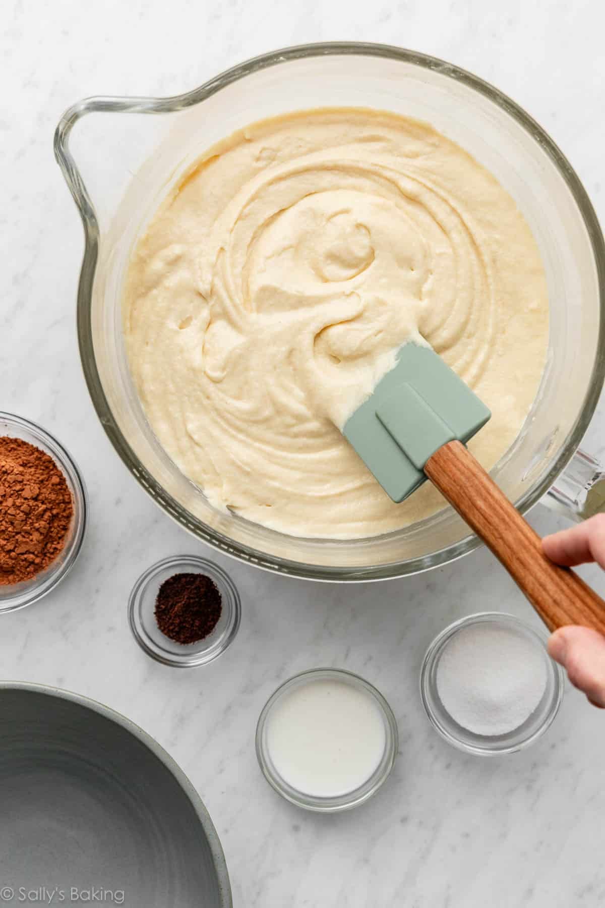 vanilla cake batter with green silicone spatula.