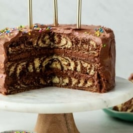 zebra layer cake with chocolate and vanilla on cake stand.