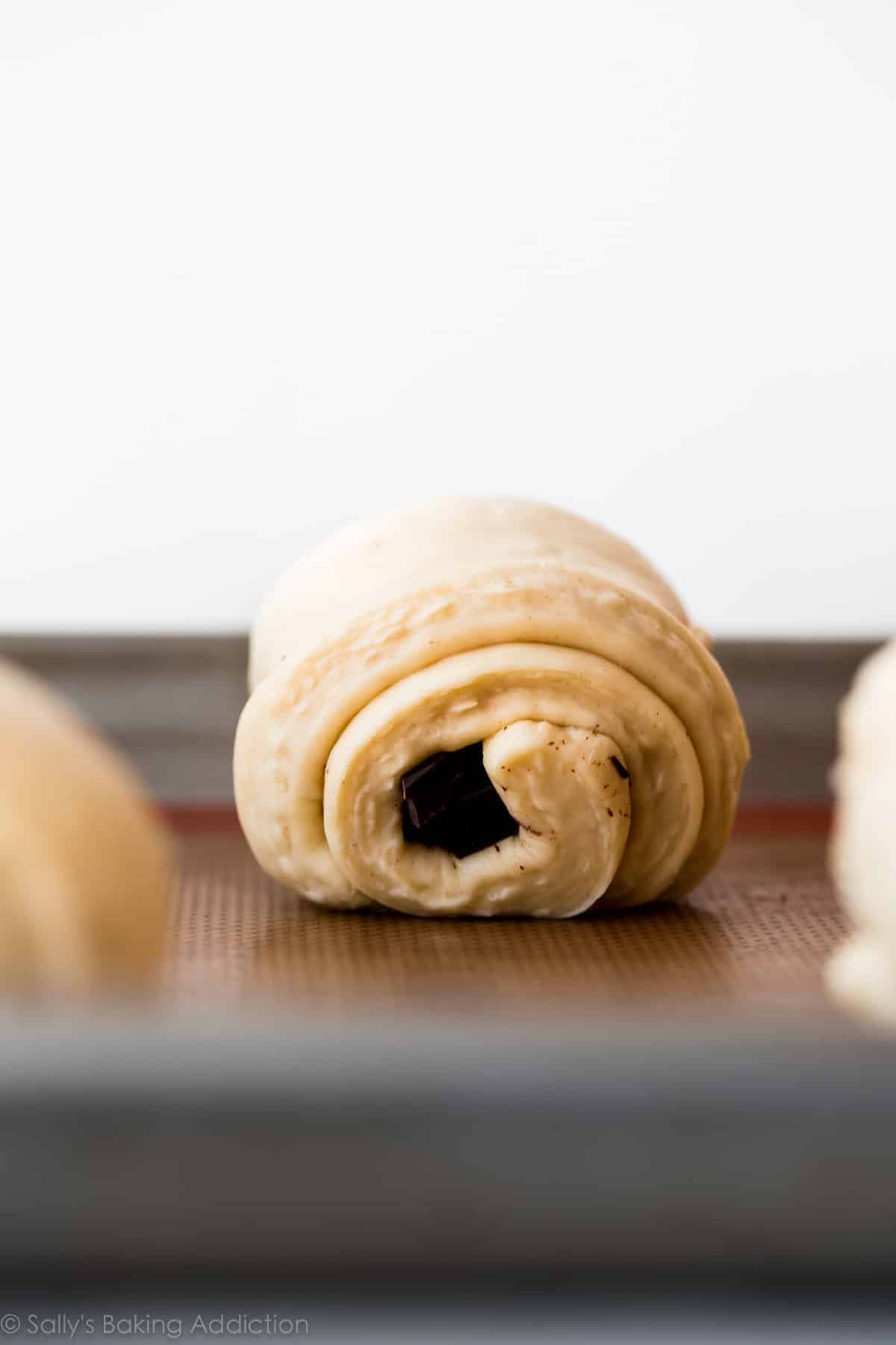 chocolate croissant on a baking sheet before baking
