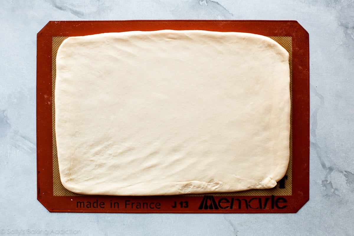 croissant dough rolled out onto a silpat baking mat
