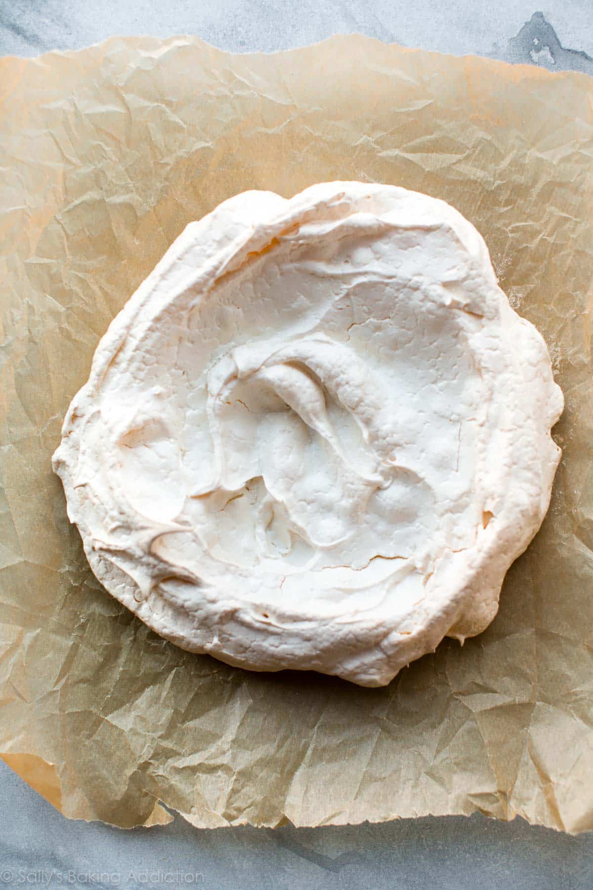 pavlova spread onto a baking sheet after baking