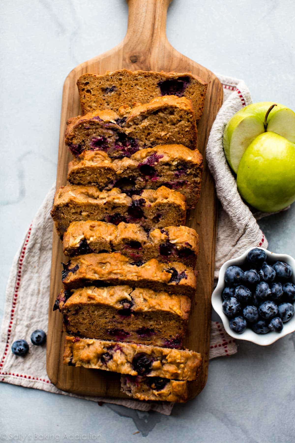 healthy apple blueberry bread slices on a wood serving tray