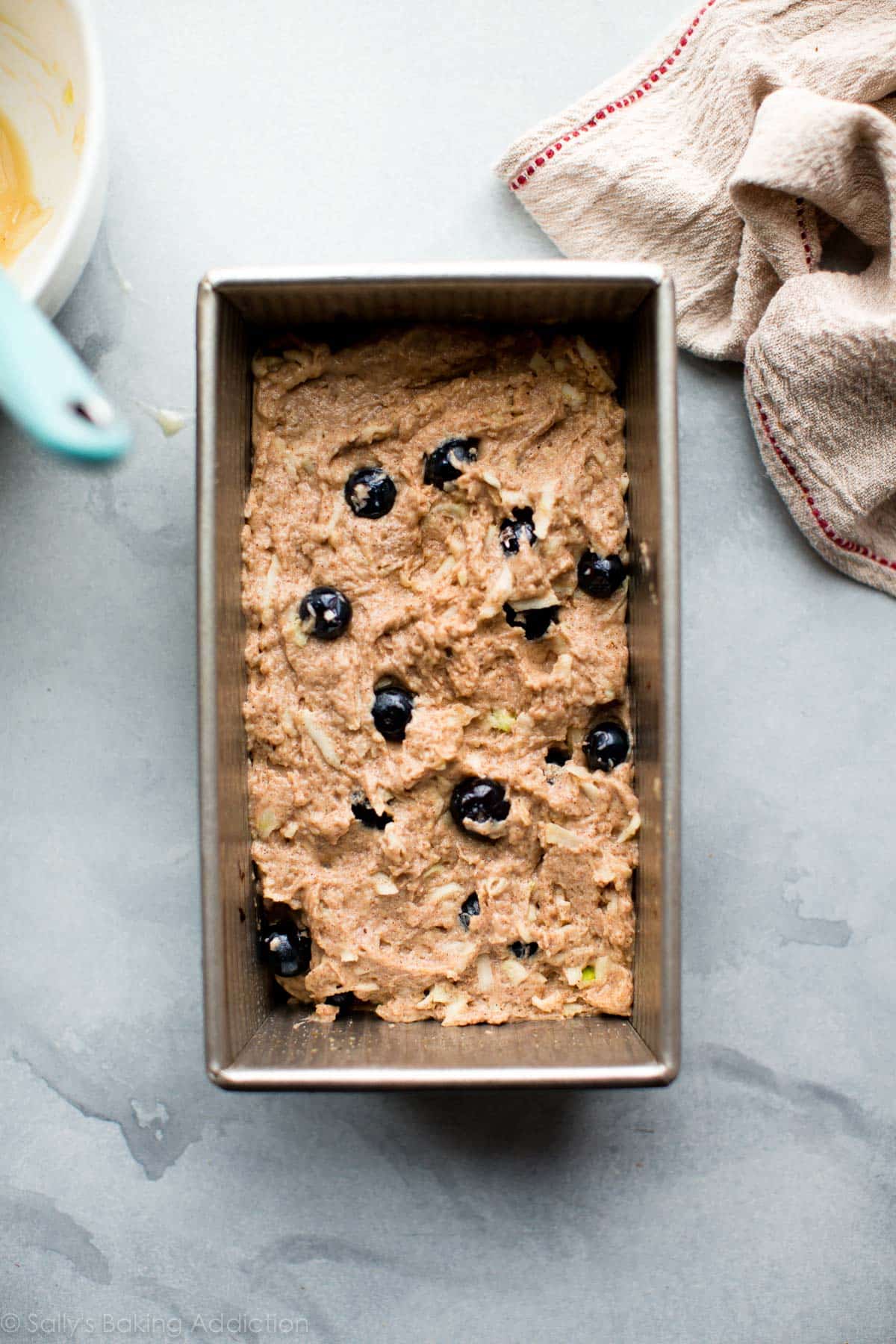 Greek yogurt apple blueberry bread batter in a loaf pan before baking