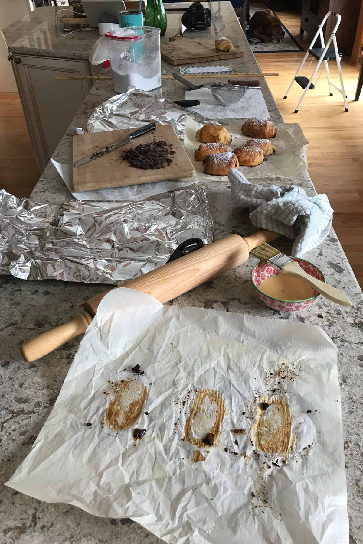 kitchen counter with croissants and baking supplies