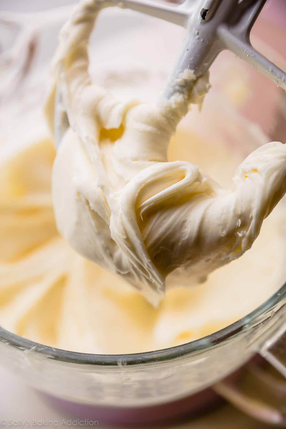 lemon cream cheese buttercream in a glass bowl with a paddle attachment
