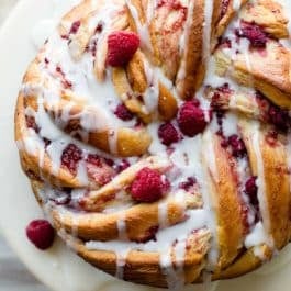 overhead image of raspberry danish twist on a cake stand