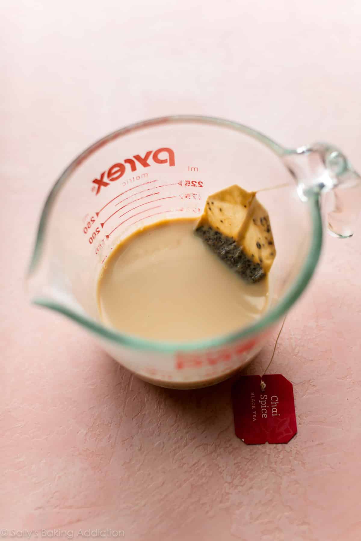 Chai tea milk in a glass measuring cup