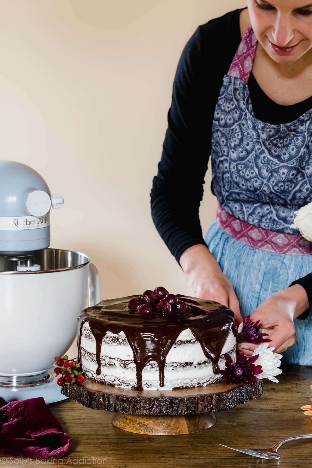 Sally decorating a black forest cake with flowers