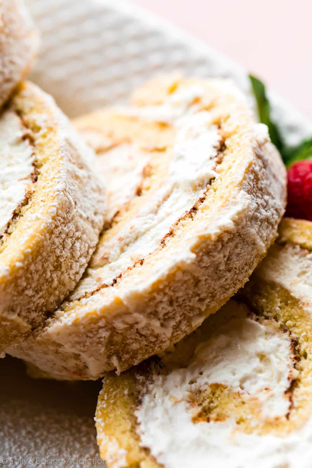 Champagne cake roll slices on a white serving platter