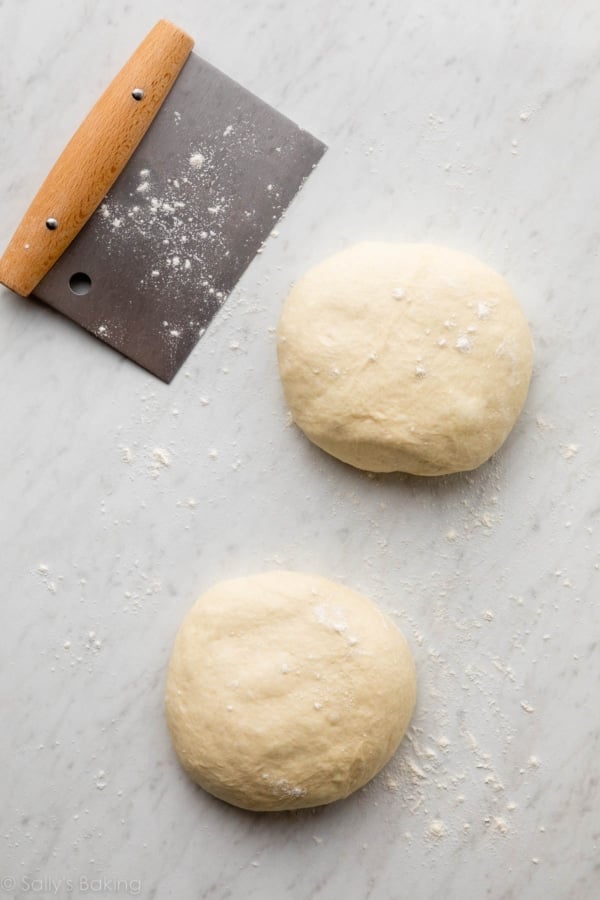 two balls of dough on floured work surface.
