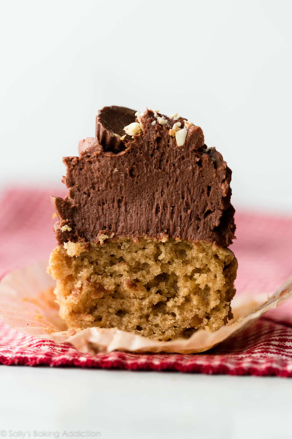 Peanut butter cupcake with chocolate frosting cut in half
