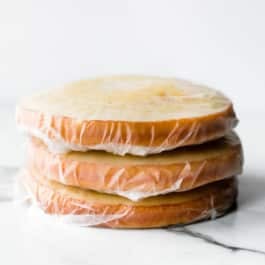 stack of wrapped cakes for freezing