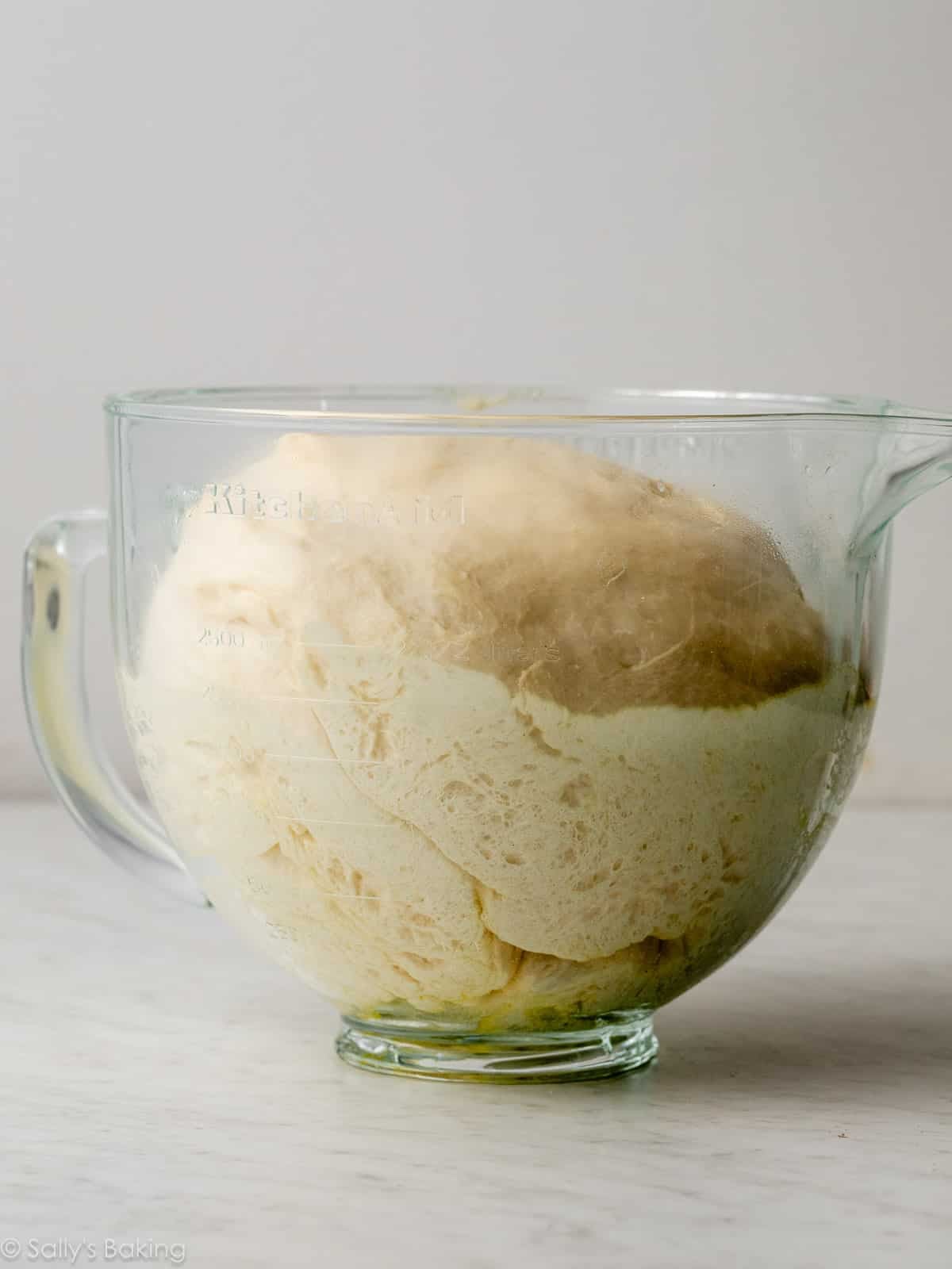 dough risen in glass bowl.