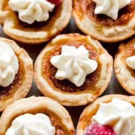 mini pumpkin pies with whipped cream on top