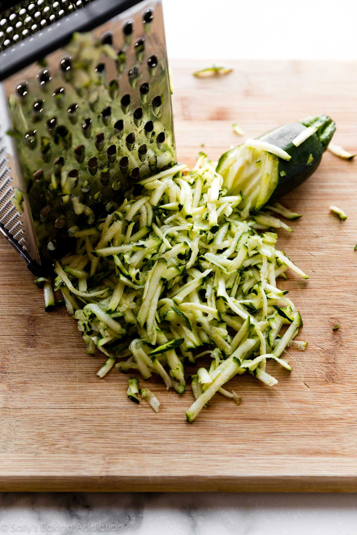shredded zucchini on cutting board